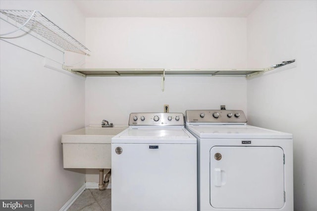 laundry area featuring separate washer and dryer and sink