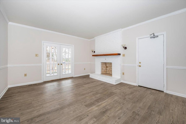 unfurnished living room with a fireplace, french doors, hardwood / wood-style floors, and ornamental molding