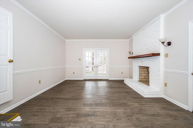 unfurnished living room featuring dark hardwood / wood-style floors, crown molding, a fireplace, and french doors