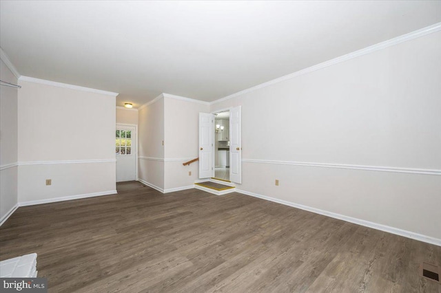 empty room with dark hardwood / wood-style floors and ornamental molding