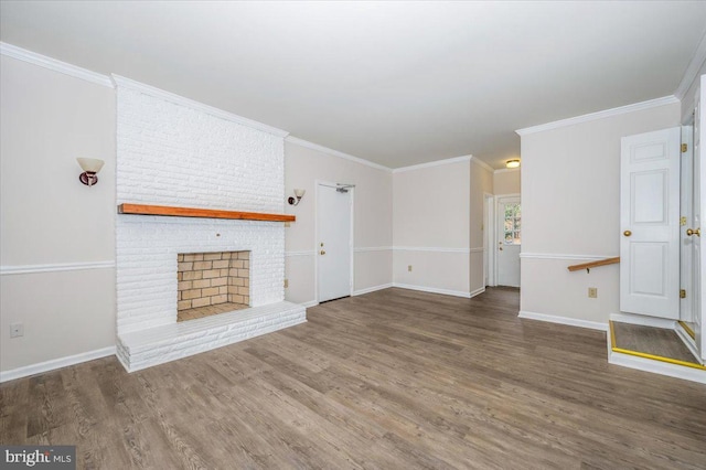 unfurnished living room featuring a fireplace, crown molding, and dark wood-type flooring