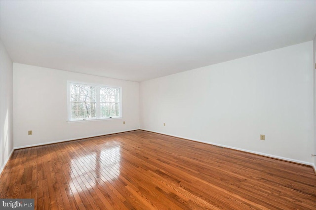 unfurnished room featuring hardwood / wood-style flooring