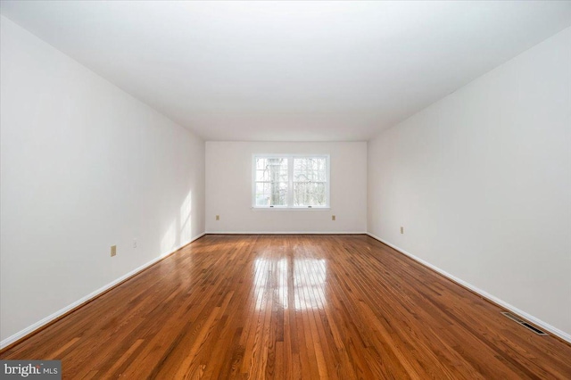 spare room with wood-type flooring