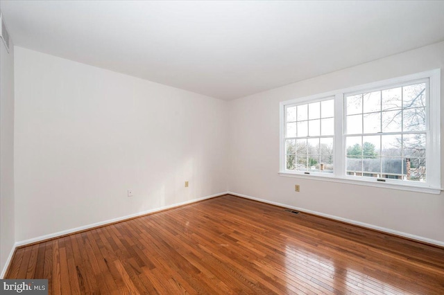 spare room with wood-type flooring