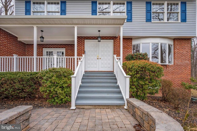 view of exterior entry with a porch