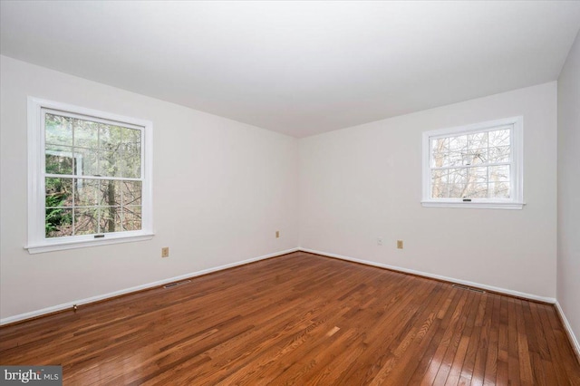 spare room featuring hardwood / wood-style floors