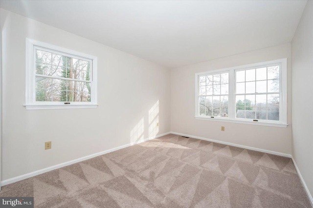 unfurnished room with light carpet