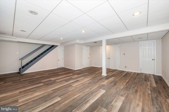 basement with dark hardwood / wood-style floors