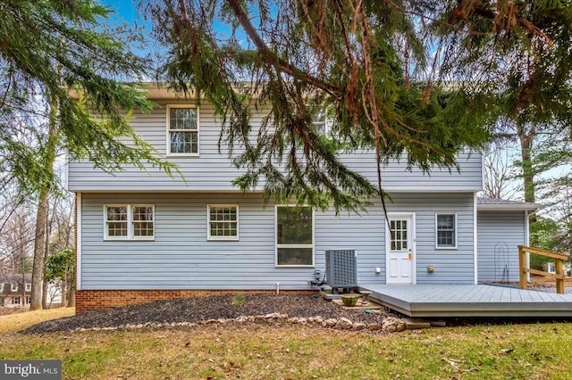 rear view of property featuring a wooden deck