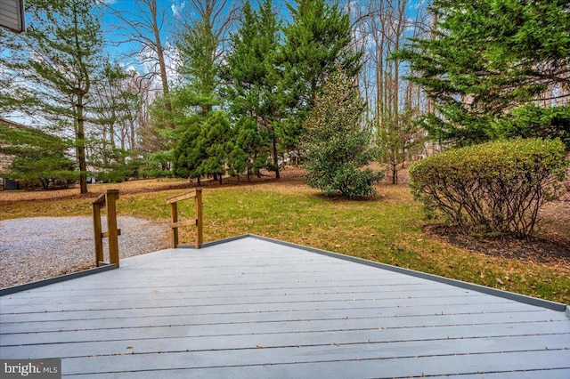 wooden terrace featuring a yard