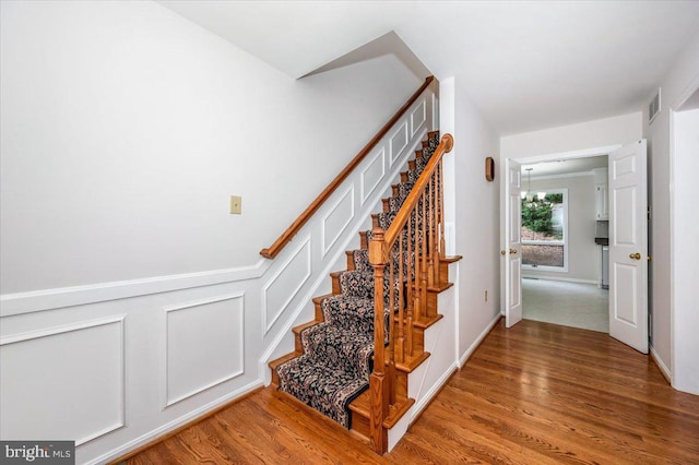 stairs featuring hardwood / wood-style flooring