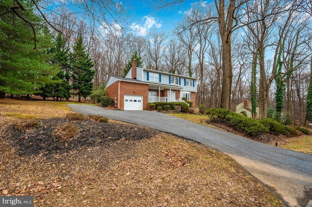 front of property with a porch and a garage