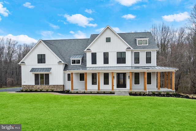 modern farmhouse style home with a front yard and a porch