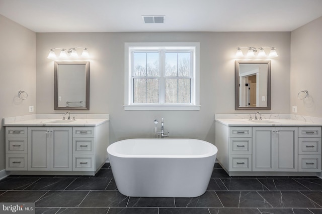 bathroom featuring vanity and a tub