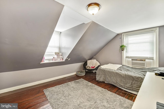 bedroom with cooling unit, wood-type flooring, vaulted ceiling, and baseboards