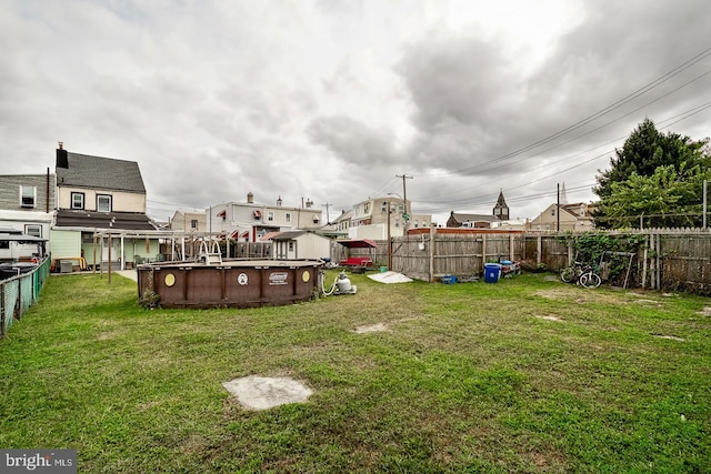 view of yard featuring a fenced backyard and a fenced in pool