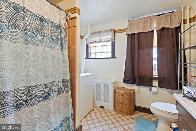 bathroom featuring vanity, toilet, curtained shower, and radiator