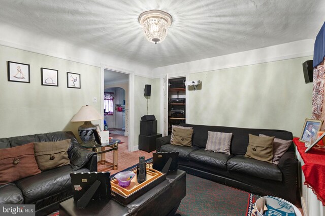 carpeted living room featuring a textured ceiling