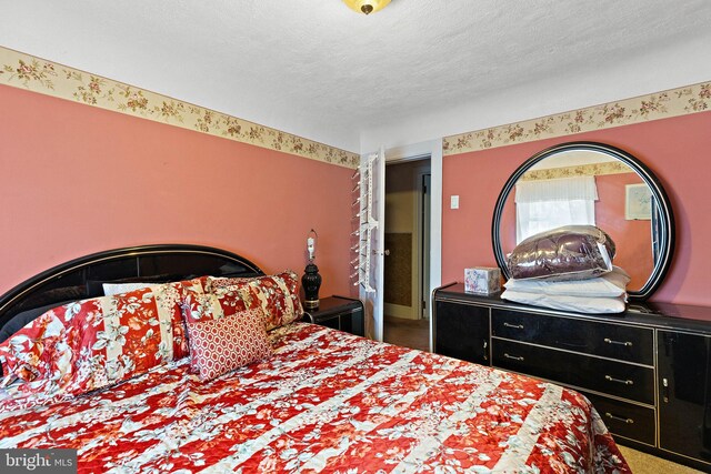 carpeted bedroom with a textured ceiling