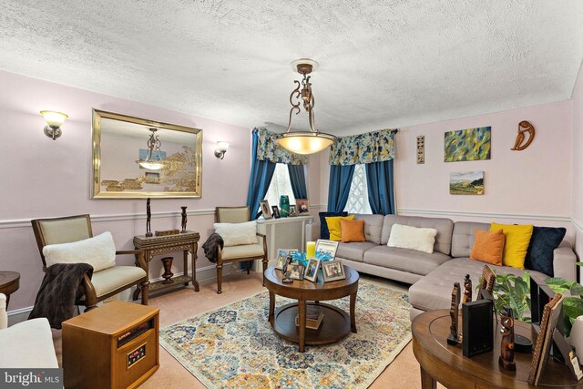 carpeted living room featuring a textured ceiling