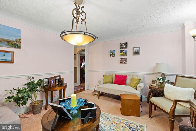 living room with light carpet and a textured ceiling