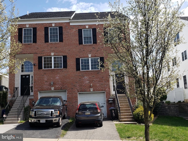 view of front of property with brick siding, driveway, and an attached garage