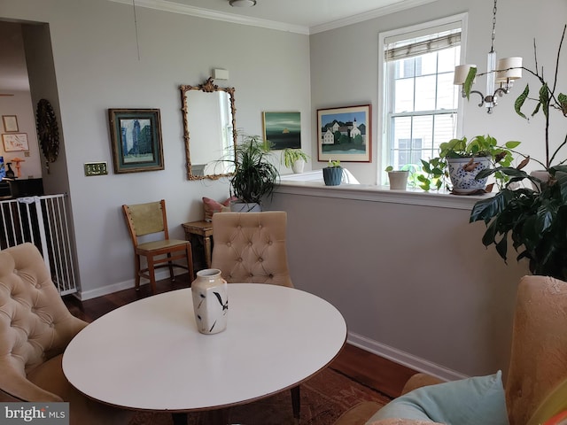 sitting room with hardwood / wood-style flooring, a chandelier, and ornamental molding