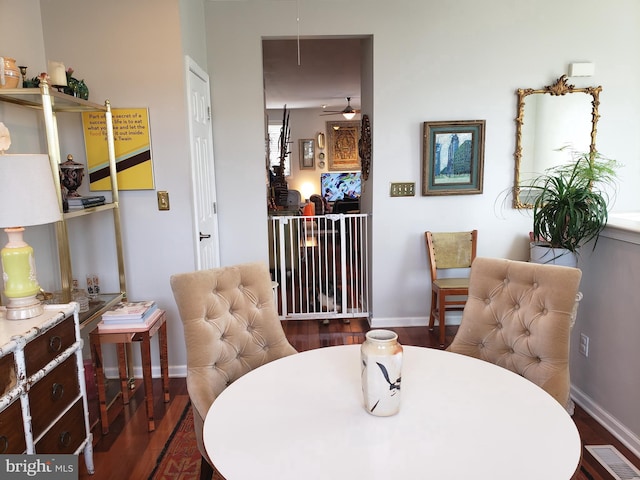 dining space featuring ceiling fan and dark hardwood / wood-style floors