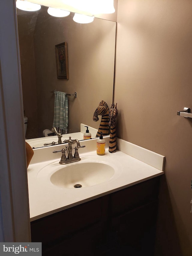 bathroom featuring vanity and toilet