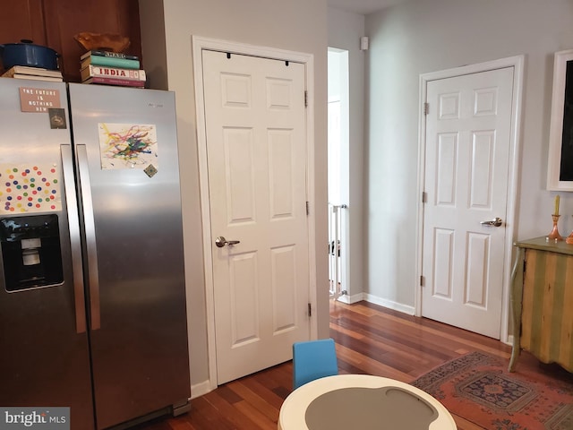 kitchen featuring dark wood-type flooring and stainless steel fridge