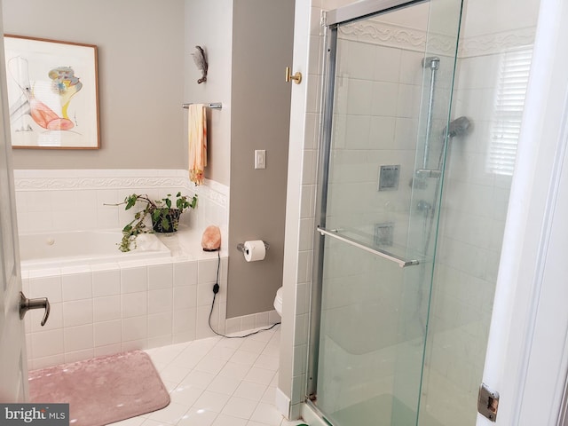 bathroom featuring toilet, plus walk in shower, and tile patterned flooring