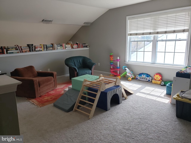 recreation room featuring carpet and vaulted ceiling