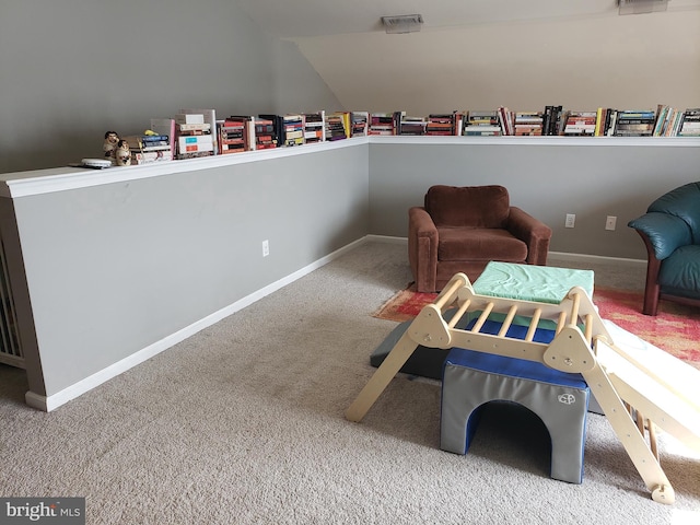 living area featuring lofted ceiling and carpet flooring