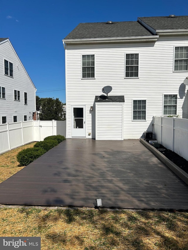 rear view of house featuring a deck