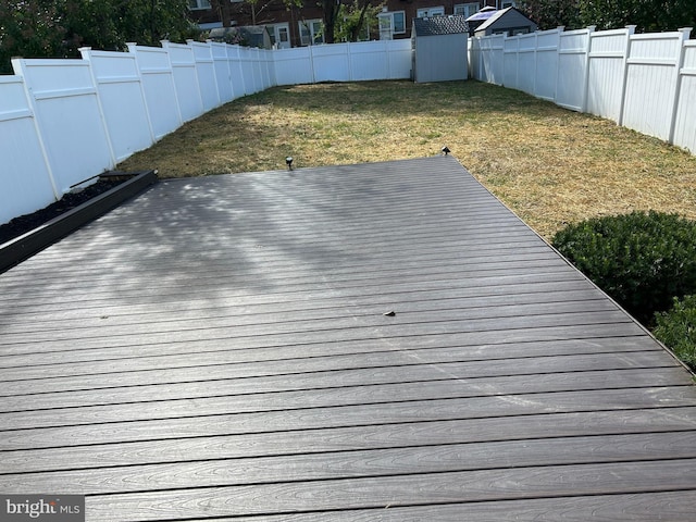 wooden terrace featuring a yard