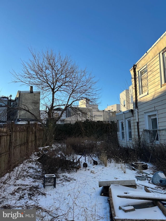 yard layered in snow with fence