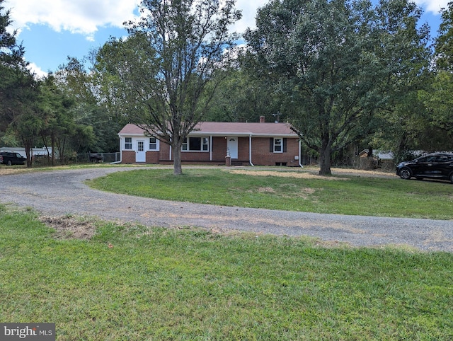 ranch-style home featuring a front yard