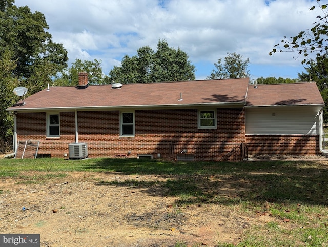 rear view of property featuring central AC