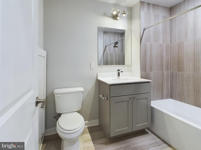 full bathroom featuring vanity, tiled shower / bath combo, toilet, and hardwood / wood-style flooring