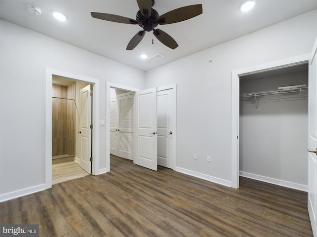 unfurnished bedroom featuring ceiling fan and dark hardwood / wood-style floors