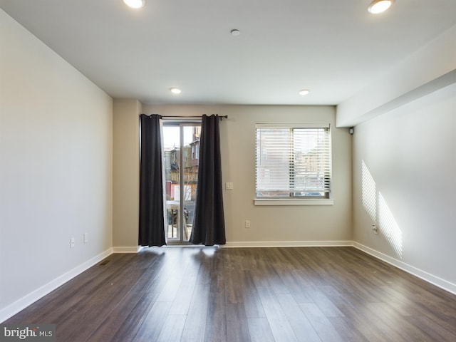 empty room with dark hardwood / wood-style floors