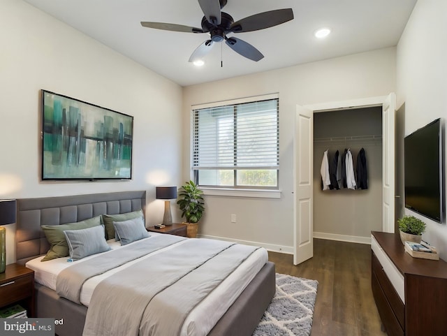 bedroom featuring dark wood-type flooring, a closet, and ceiling fan