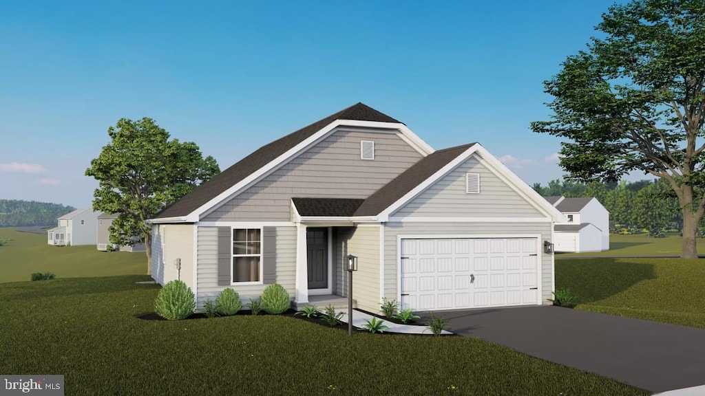 view of front of house featuring a garage and a front lawn