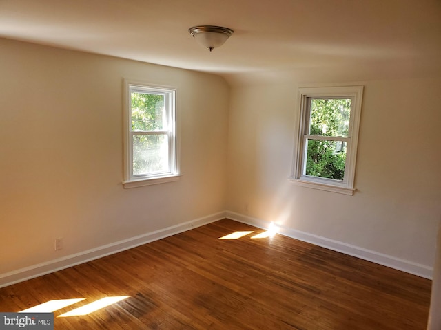 spare room with dark hardwood / wood-style floors