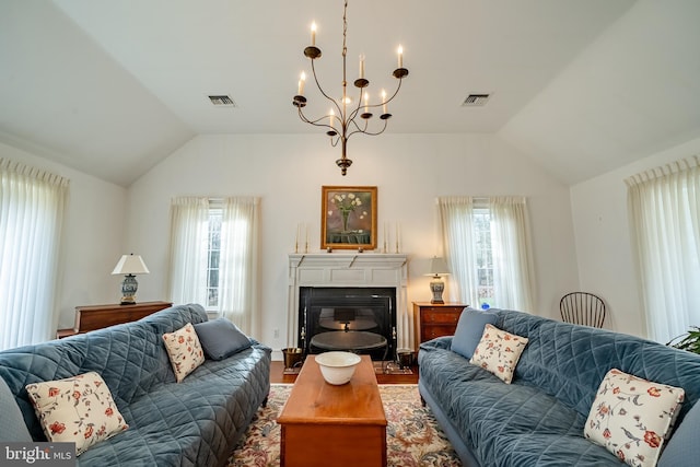 living area featuring lofted ceiling, plenty of natural light, and visible vents