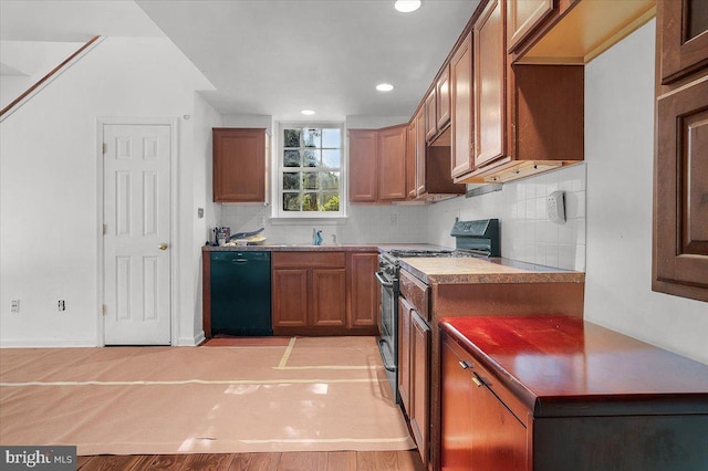 kitchen with black dishwasher, brown cabinetry, light wood-style flooring, stainless steel range with gas stovetop, and backsplash