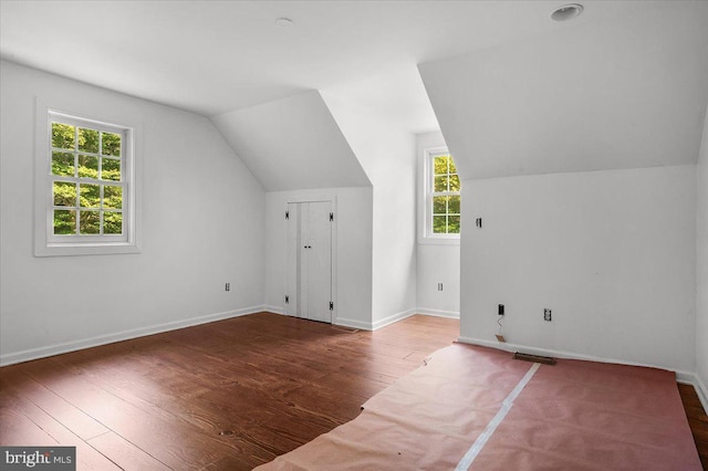 additional living space with lofted ceiling, baseboards, and hardwood / wood-style flooring