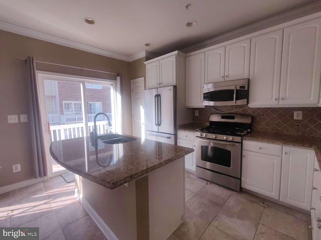 kitchen with white cabinets, stainless steel appliances, stone countertops, sink, and a kitchen island with sink