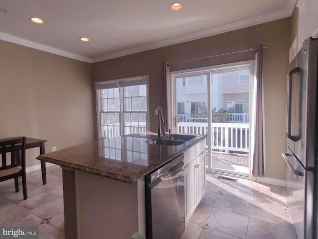 kitchen featuring plenty of natural light, stainless steel appliances, an island with sink, and white cabinetry