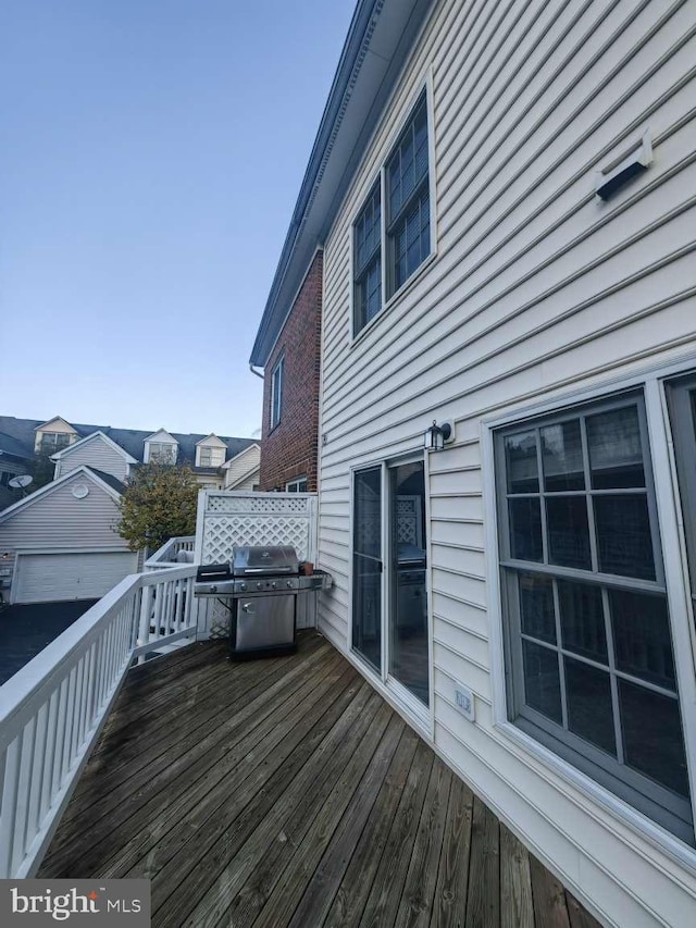 wooden deck featuring area for grilling